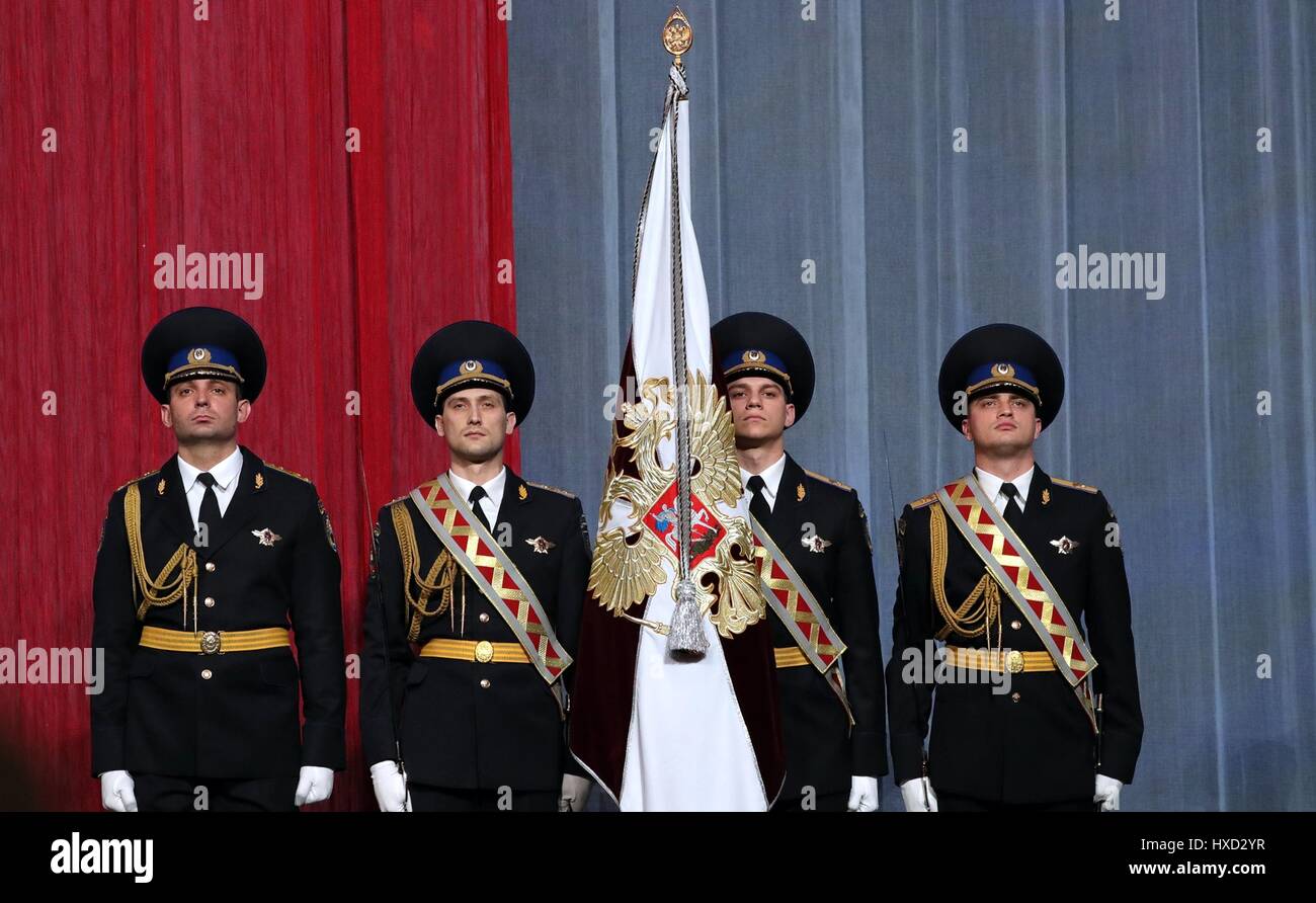 Russian National Guard soldiers stand with the flag during the National Guard Day Gala evening at the Kremlin March 27, 2017 in Moscow, Russia. This is the first celebration for the guard which was created by Putin in 2017 to fight terrorism and organized crime. Stock Photo