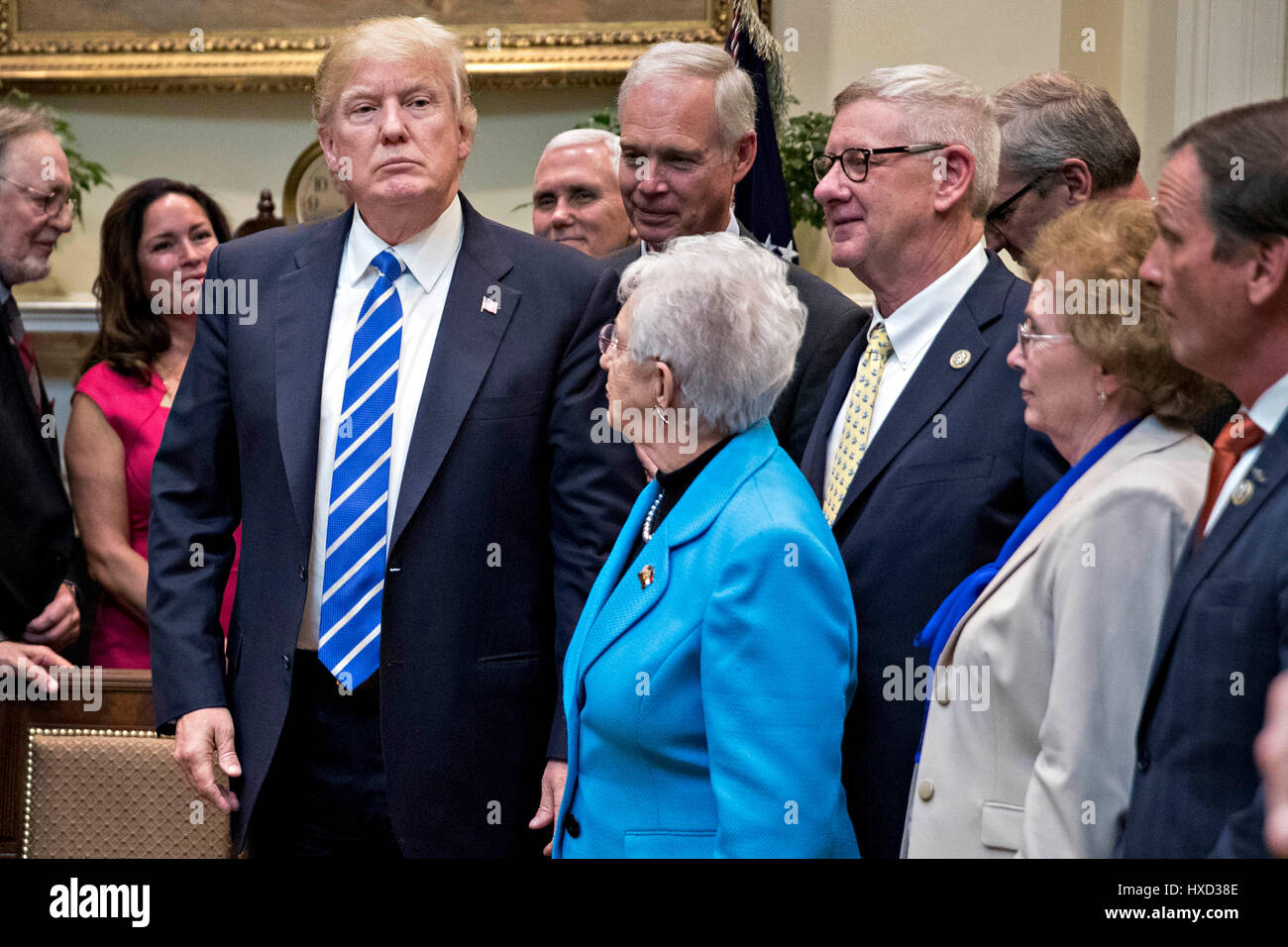 Washington DC, USA. 27th March, 2017. United States President Donald Trump, left, stands after signing bills in the Roosevelt Room of the White House in Washington, DC, U.S., on Monday, March 27, 2017. Trump signed four bills, H.J. Res 37, H.J. Res 44, H.J. Res. 57 and H.J. Res. 58, that nullify measures put in place during former President Barack Obama's administration. Credit: MediaPunch Inc/Alamy Live News Stock Photo