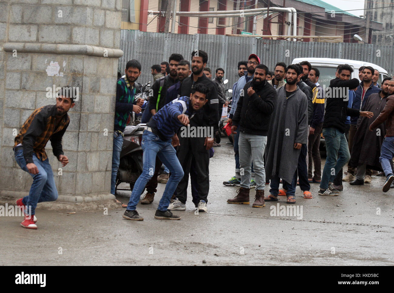 Srinagar, Kashmir. 28th March 2017. Kashmiri Protesters throw bricks at (unseen)Indian police near the hospital after received the body .One person was killed and four others were injured today in security forces' action against stone-pelting protesters near the encounter site in Chadoora area of central Kashmir's Budgam district.Security forces launched a cordon and search operation in Durbugh area of Chadoora in the early hours following information about the presence of terrorists in the area, a police official said. Credit: Sofi Suhail/Alamy Live News Stock Photo