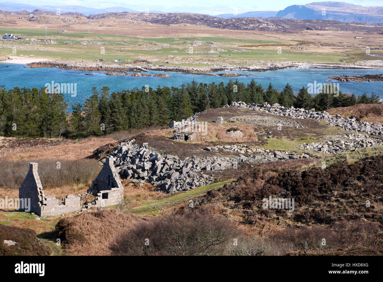 Abandoned cottage and stone maze circle on the Isle of Erraid, with Fidden on the Isle of Mull in the Inner Hebrides of Scotland in the background Stock Photo