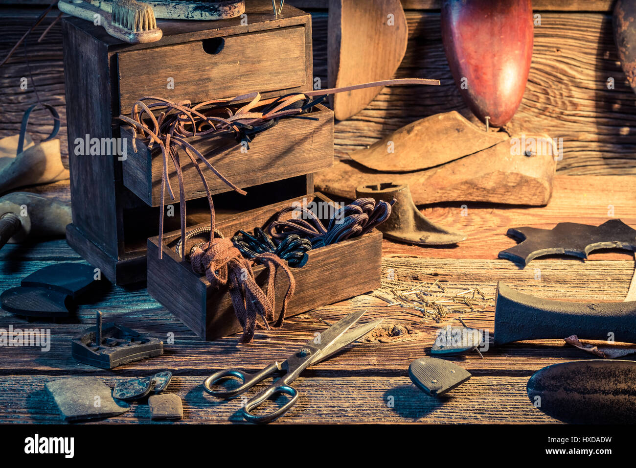 Shoemaker workplace with shoes, laces and tools Stock Photo - Alamy