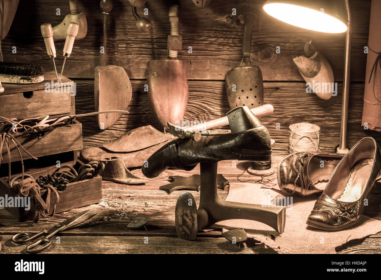 Vintage shoemaker workplace with tools, shoes and laces Stock Photo - Alamy