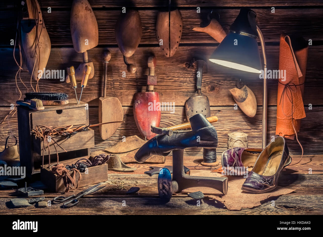 Vintage shoemaker workplace with brush and shoes Stock Photo - Alamy