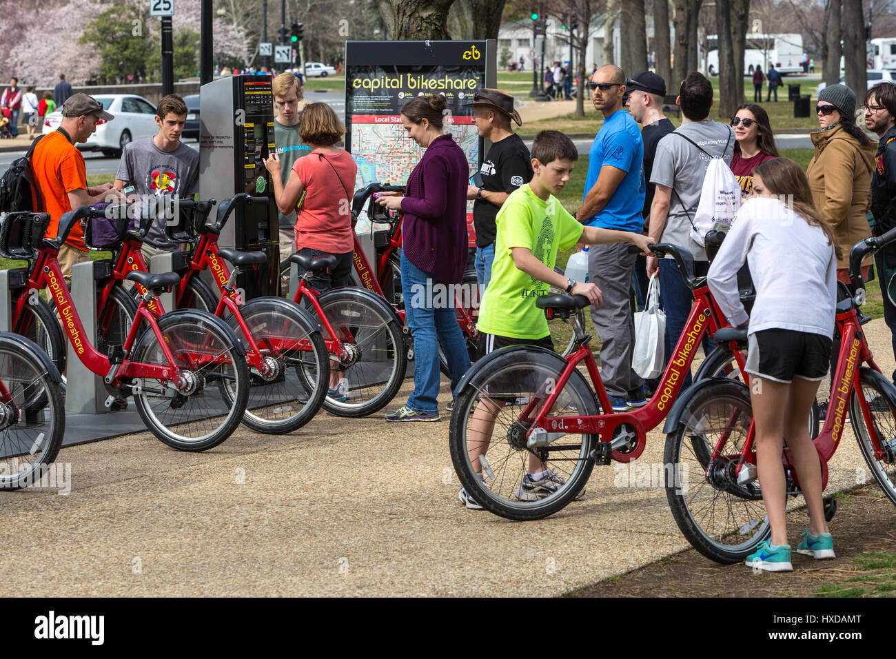 People rent bikes at a Capitol Bikeshare docking station in Washington, DC. Stock Photo