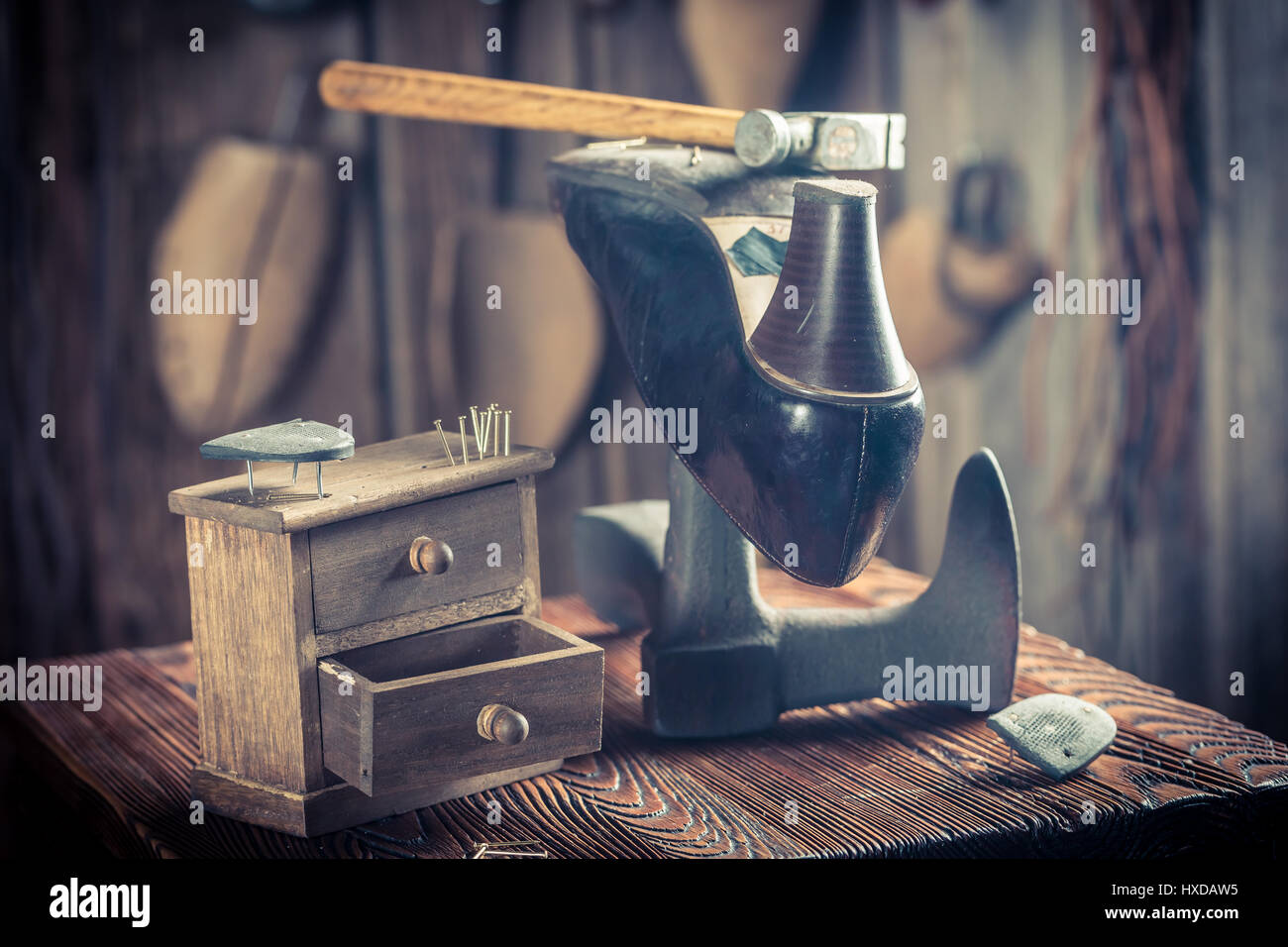 Aged shoemaker workshop with tools, shoes and leather Stock Photo - Alamy