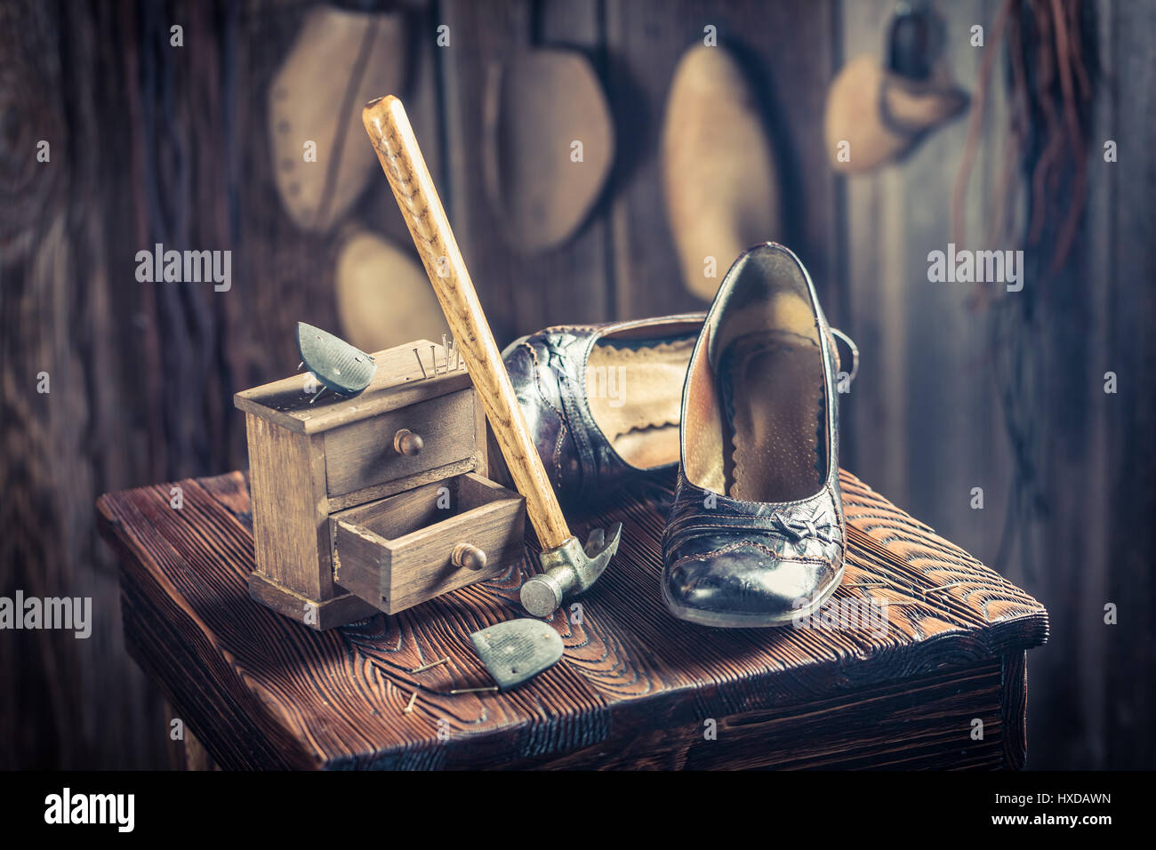 Aged shoemaker workplace with tools, leather and shoes Stock Photo - Alamy