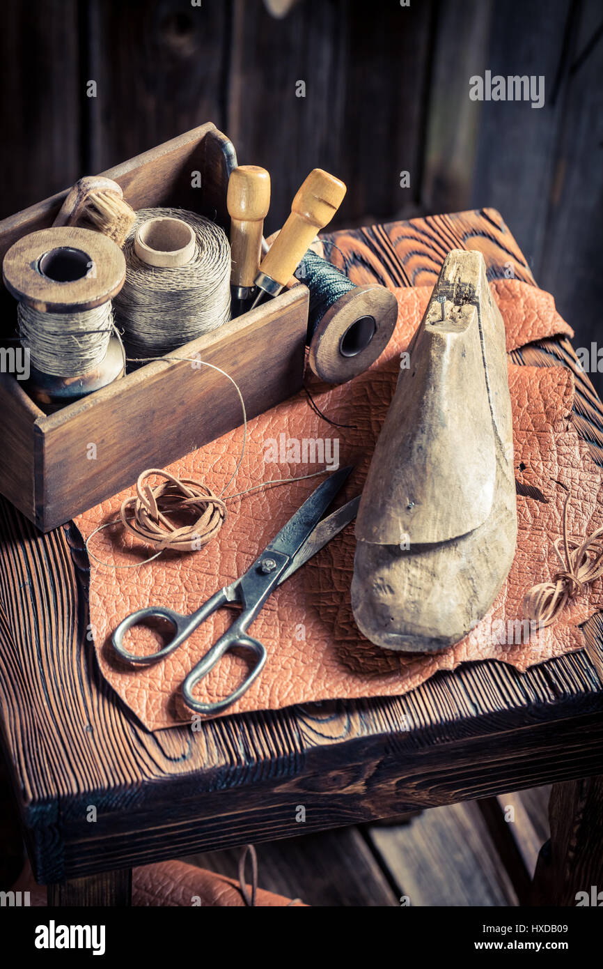Small shoemaker workplace with tools, shoes and leather Stock Photo - Alamy