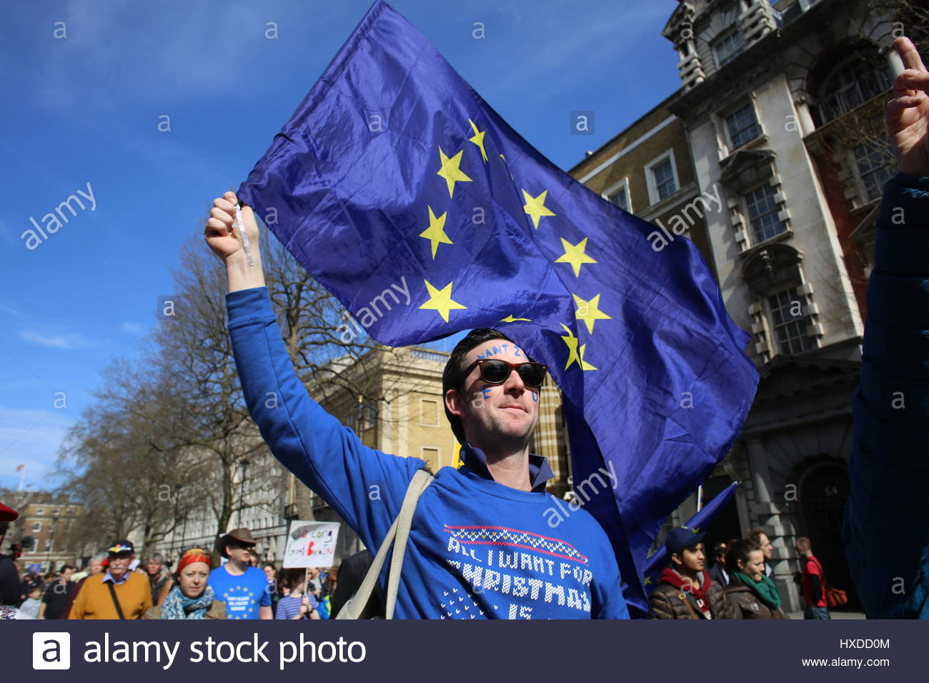 A man in blue waves an EU flag while taking part in a Unite for Europe protest in London, Britain, four days before Article 50 was triggered Stock Photo