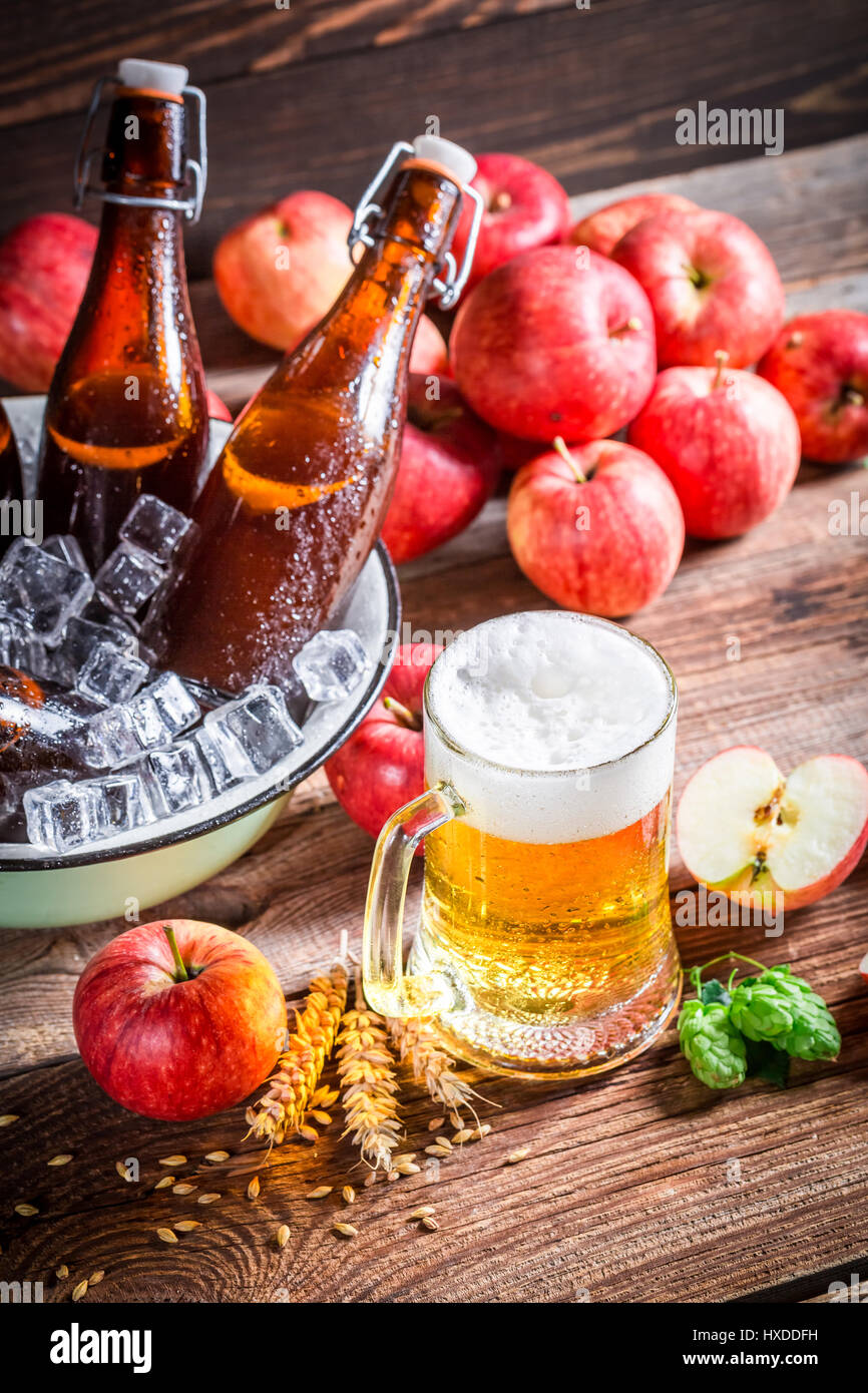 Cold and fresh cider beer with red apples Stock Photo
