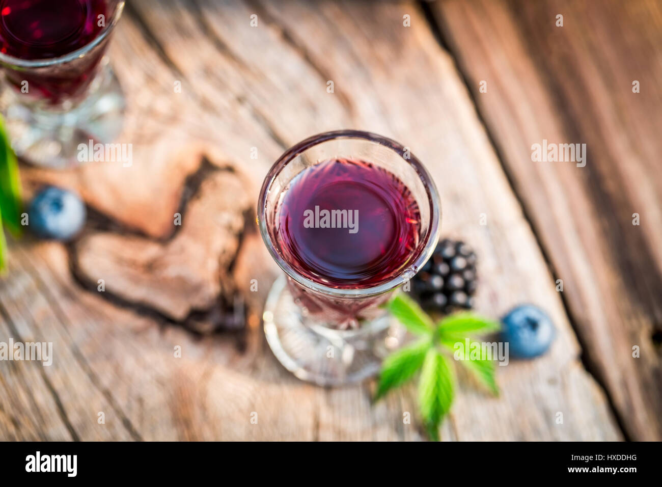 Red liqueur with berry fruits and alcohol Stock Photo Alamy