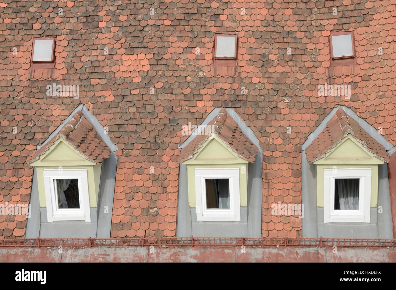 Dormer Windows On A Red Tile Roof In A Building Of Graz The