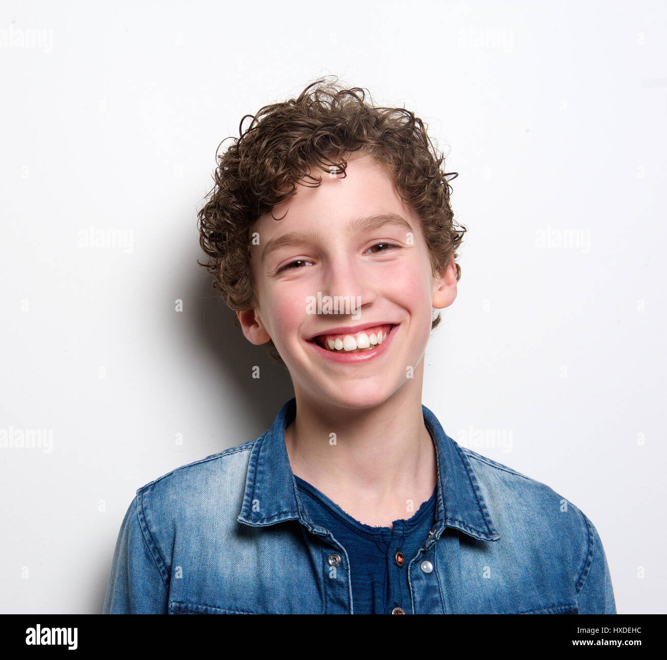 Close up portrait of a cute boy laughing on white background Stock ...