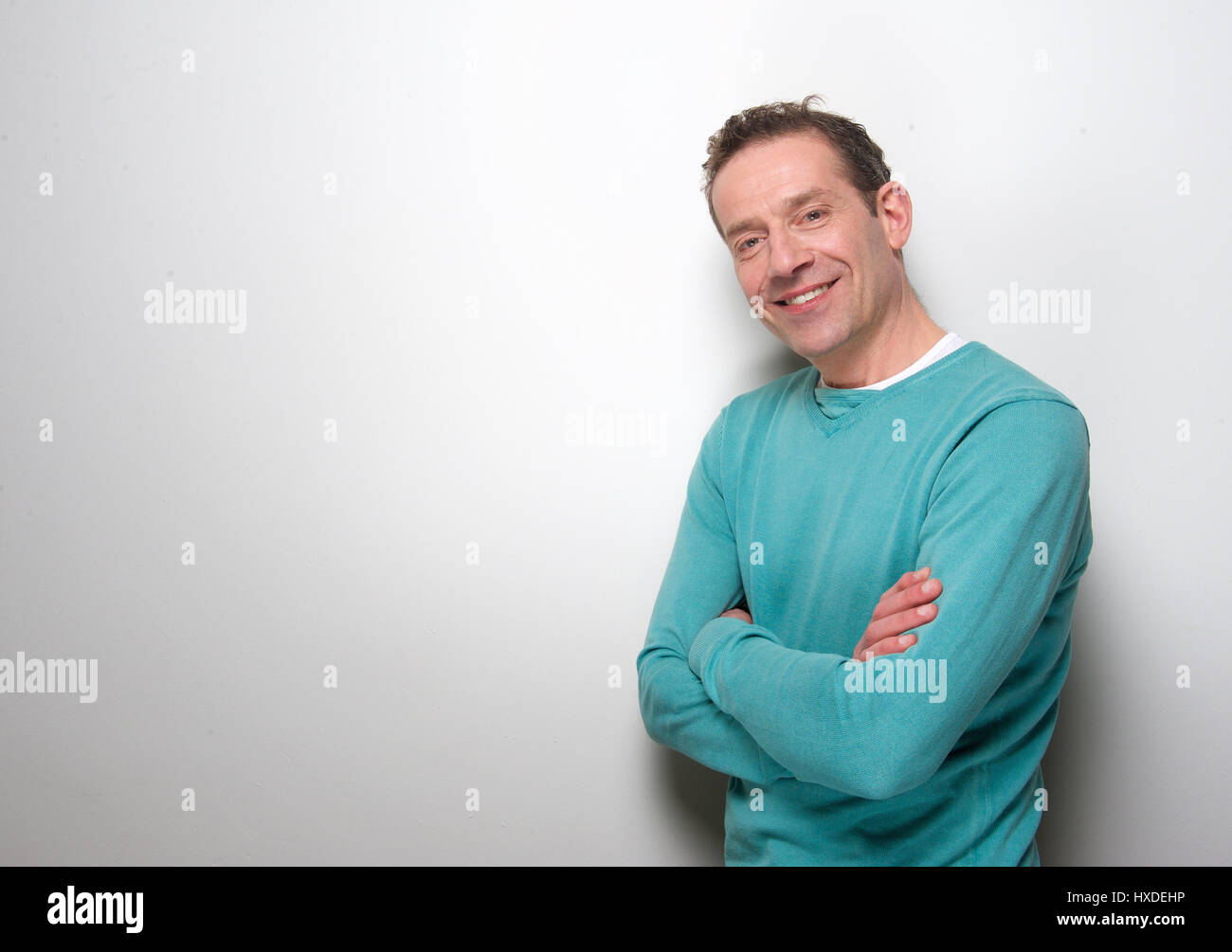 Portrait of a relaxed middle aged man smiling with arms crossed Stock ...