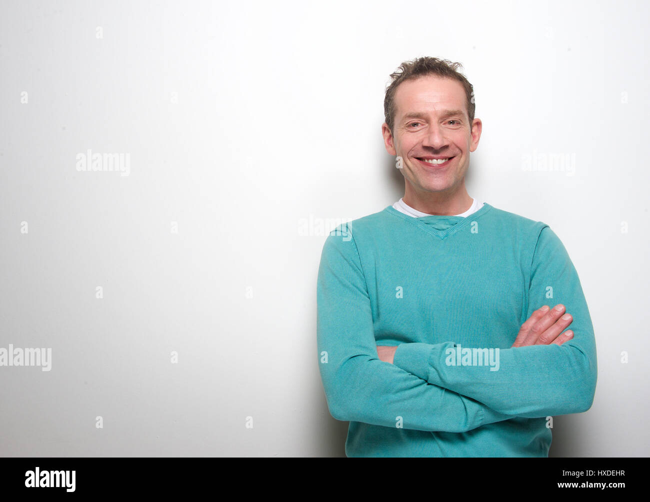 Portrait of a happy middle aged man smiling with arms crossed Stock ...