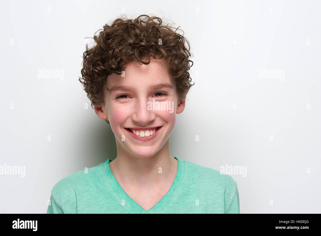 Close up portrait of a happy boy smiling against white background Stock ...