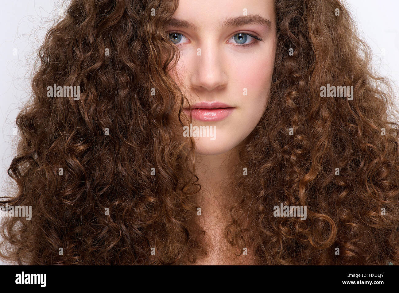 Close up portrait of a beautiful young girl with curly hair Stock Photo ...