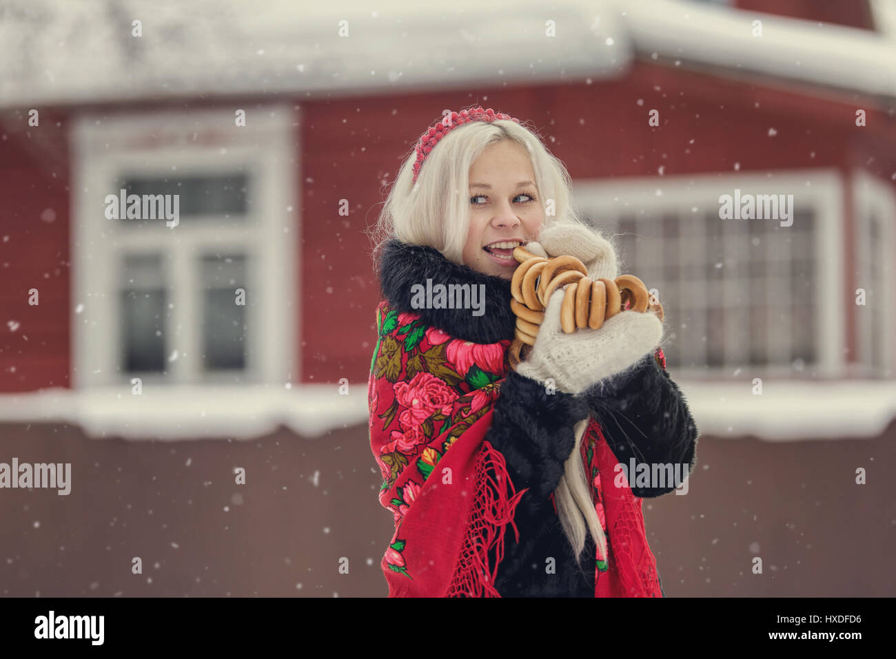 Portrait of a young caucasian woman in russian style on a strong frost in a winter snowy day. Russian model girl in traditional dress Stock Photo