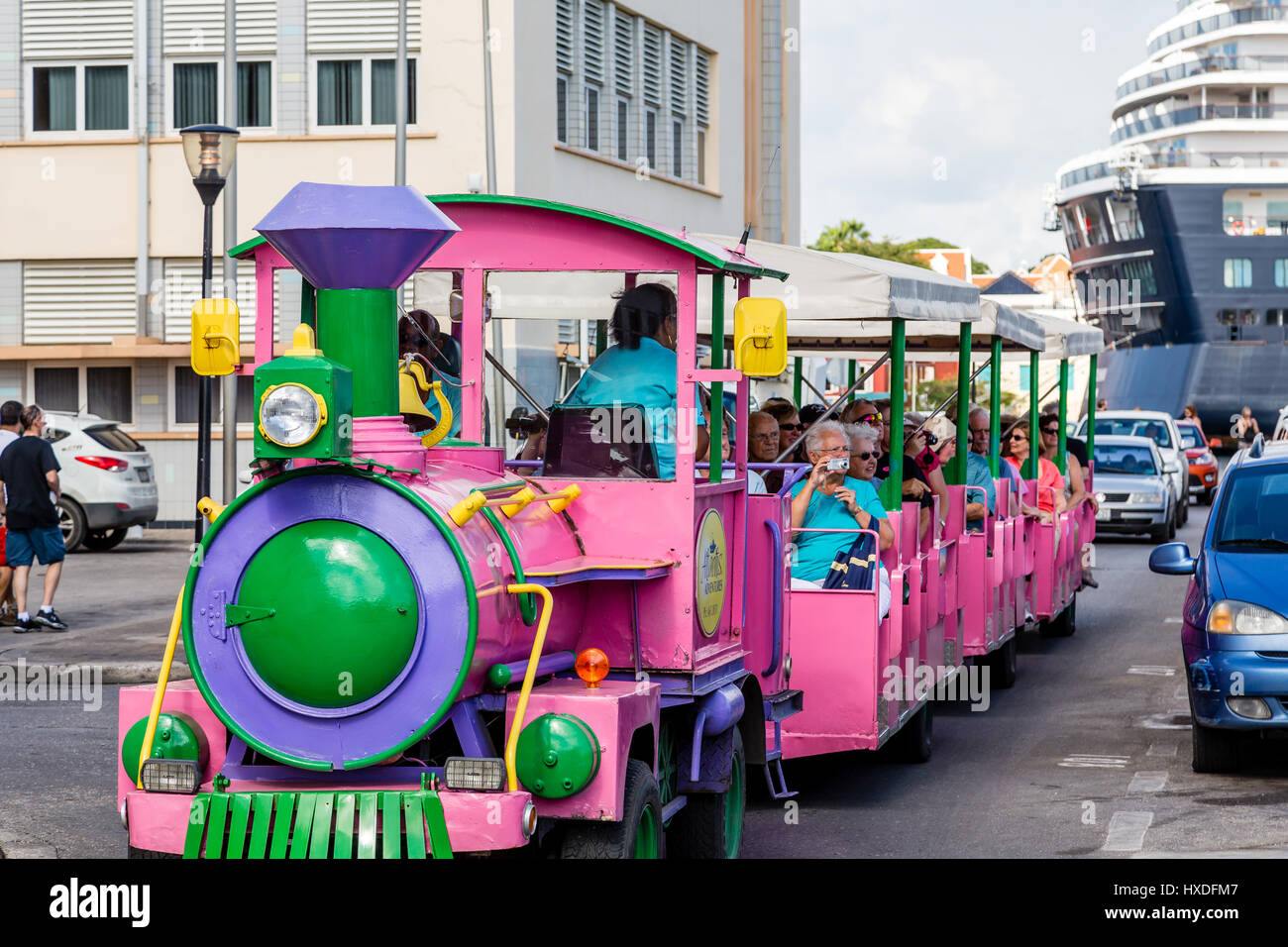 Pink Train in Curacao full of tourists Stock Photo - Alamy