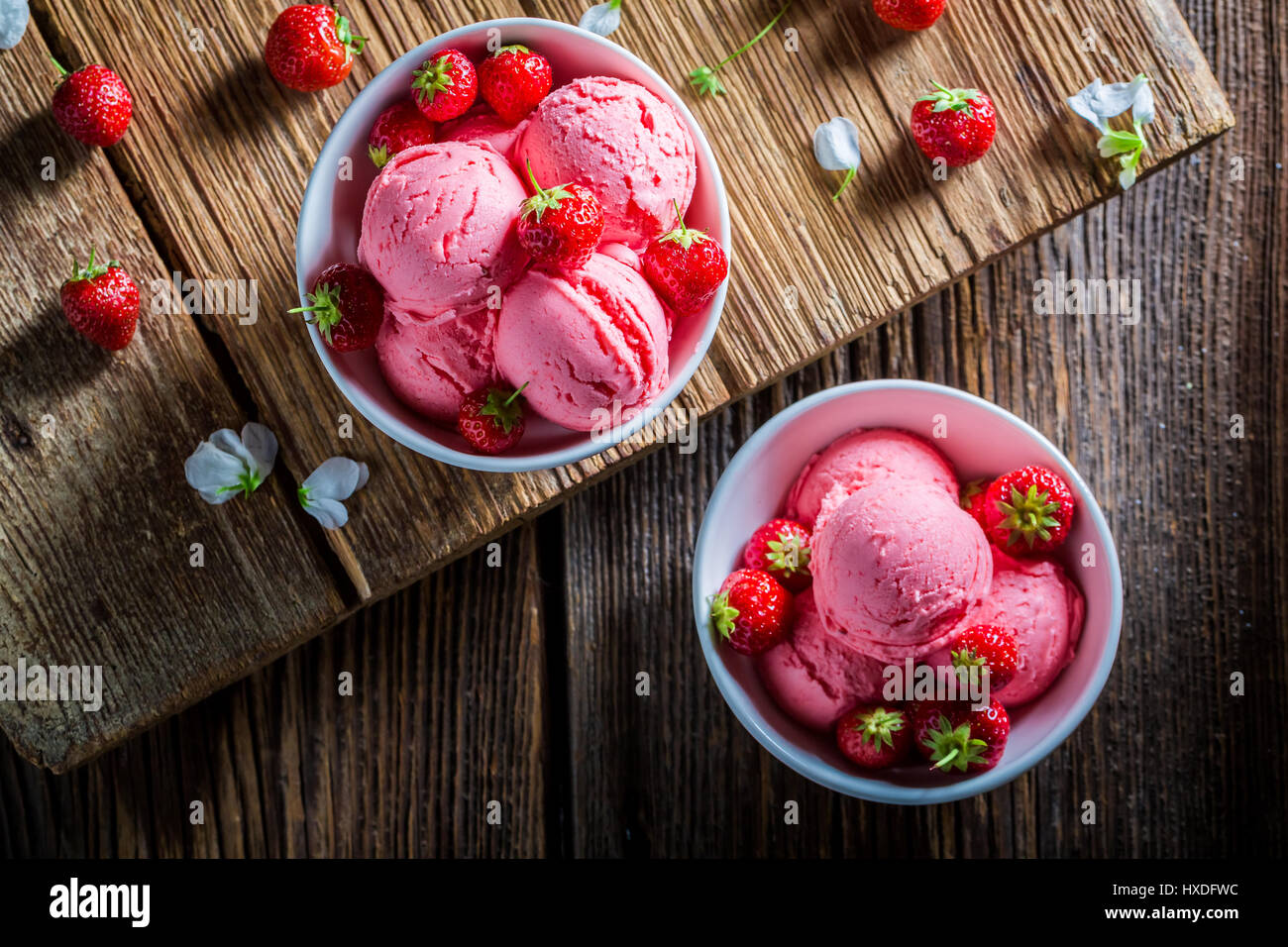 Sweet strawberries ice cream with mint leaves and flowers Stock Photo ...
