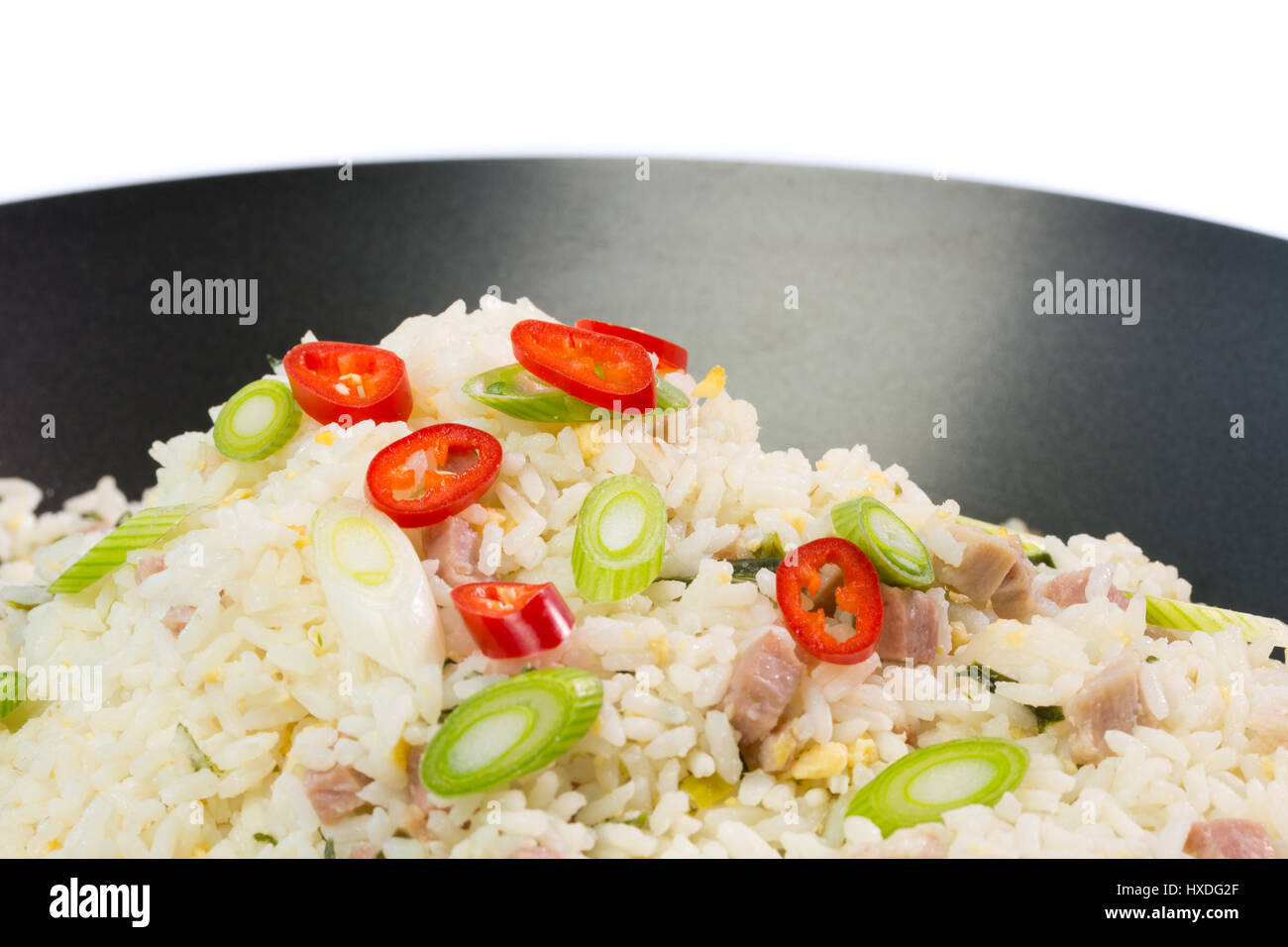 Indonesian Nasi Goreng (fried rice) with a garnish of red pepper and spring onion Stock Photo