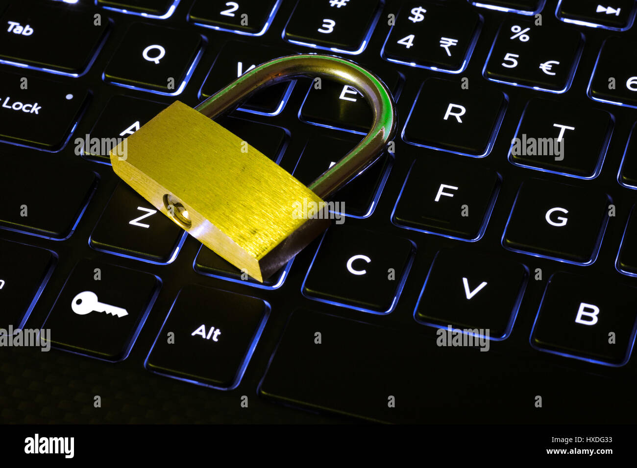 Closed lock and key button on a backlit computer keyboard Stock Photo