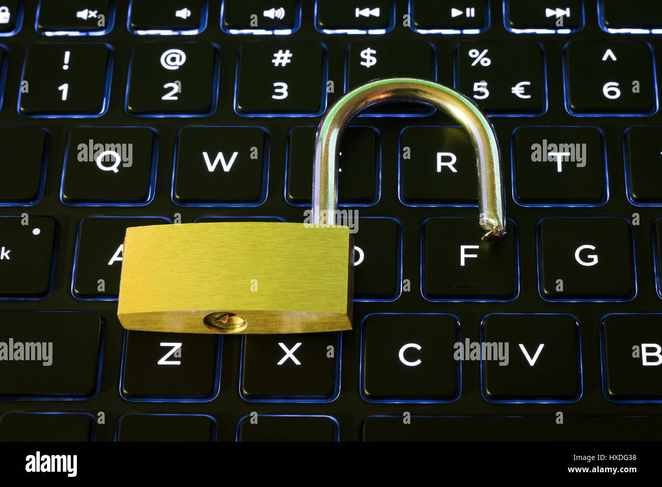 Open security lock on a backlit computer keyboard Stock Photo