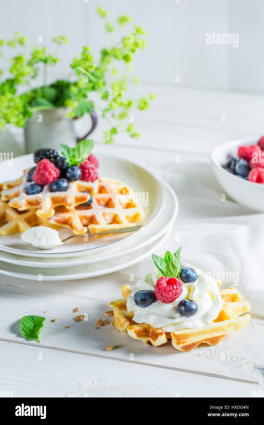 Sweet waffels with berry fruits and whipped cream Stock Photo - Alamy