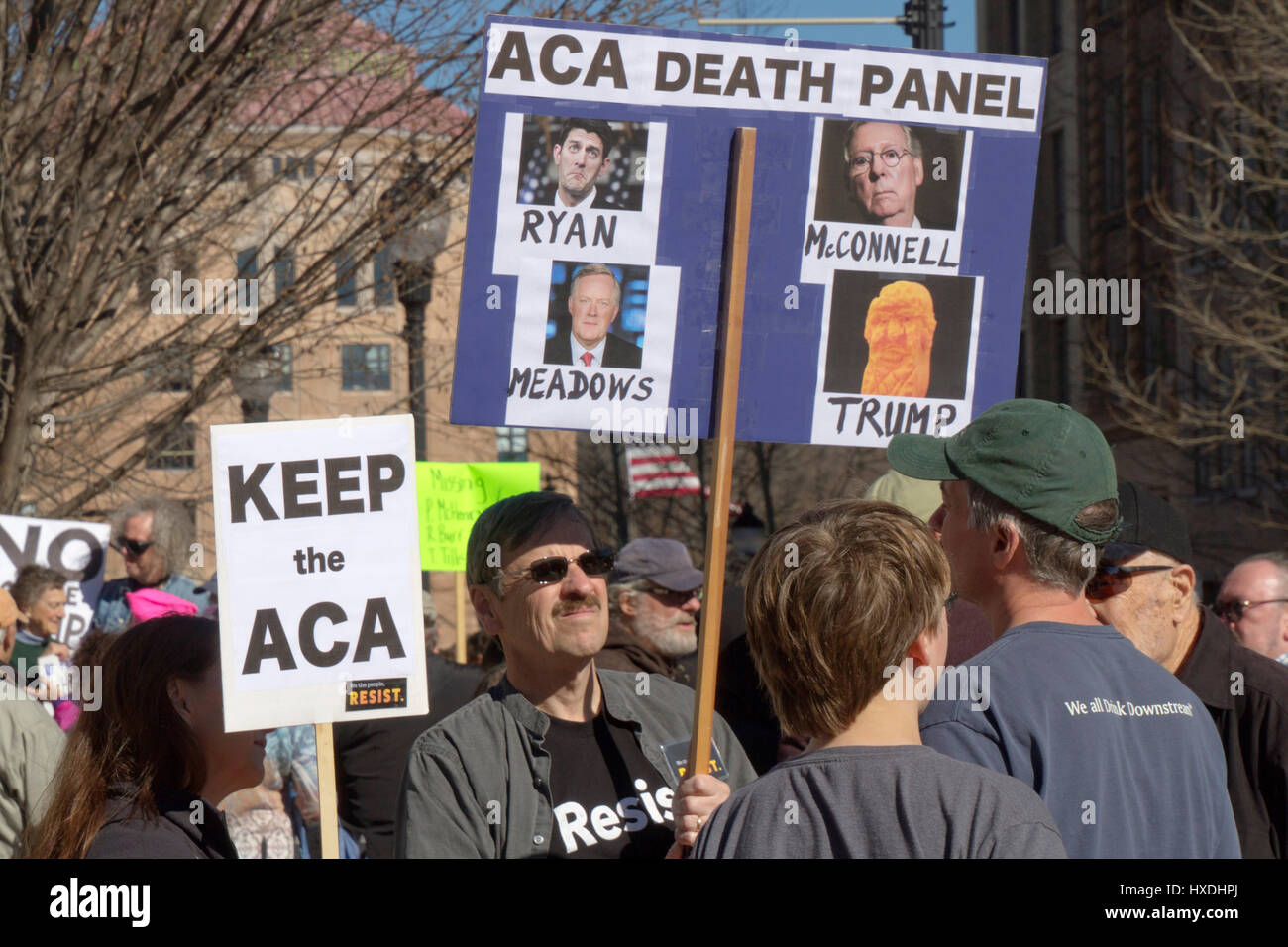 Asheville, North Carolina, USA - February 25, 2017: Activists hold Affordable Care Act (ACA) signs depicting Rupublicans Mark Meadows, Paul Ryan, Mitc Stock Photo