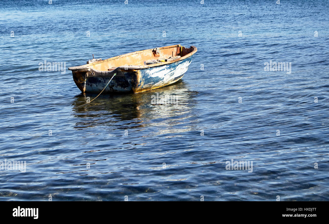 Old, rusty, empty, small boat on Aegean sea in Turkbuku town in Bodrum  peninsula Stock Photo - Alamy