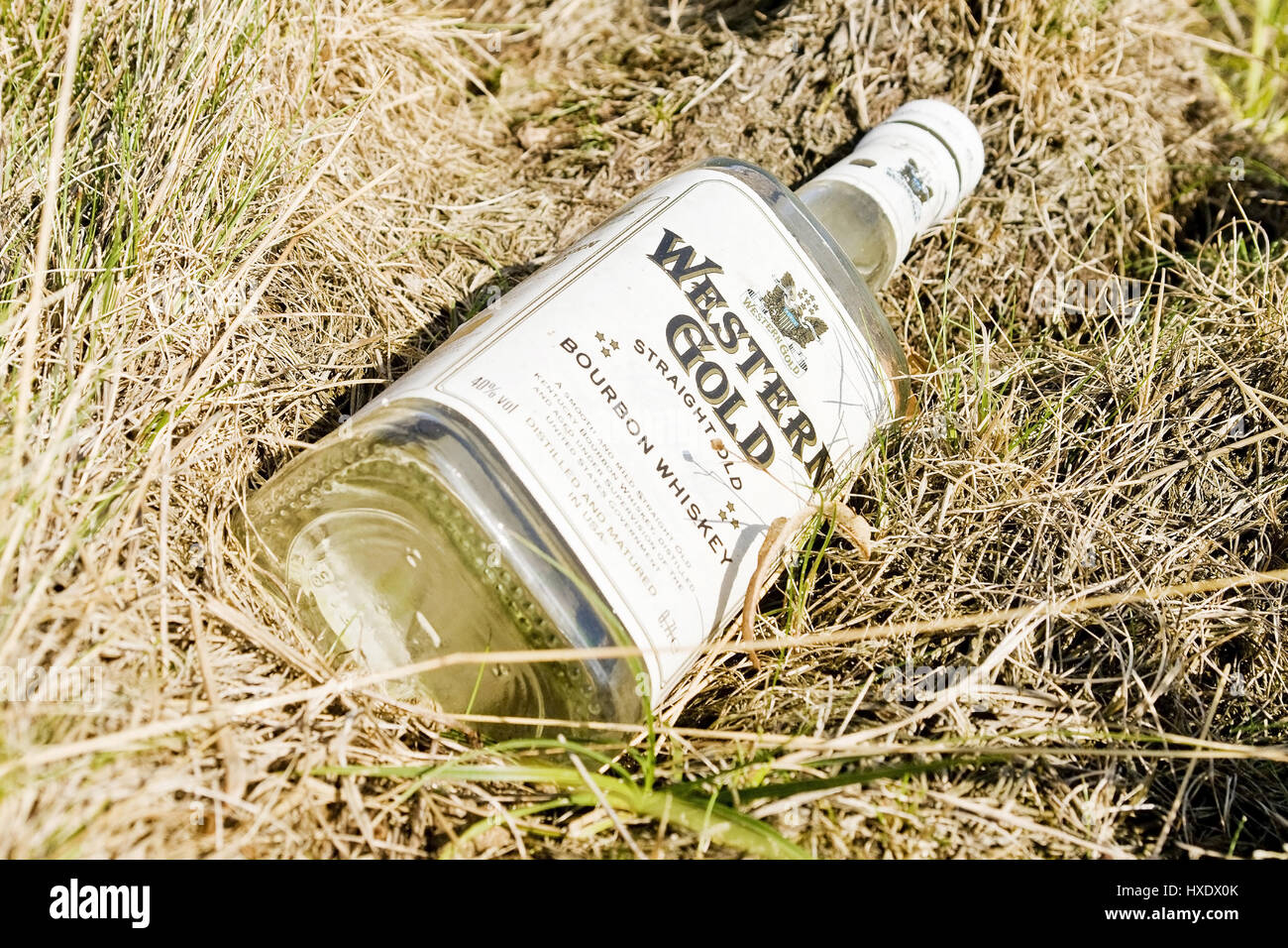 Empty bottle of whisky in the street edge, Empty bottle of whisky on the roadside |, Leere Flasche Whiskey am Strassenrand |Empty bottle of whiskey on Stock Photo