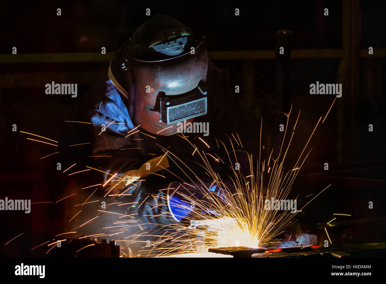 Welder is welding assembly automotive part in car factory Stock Photo