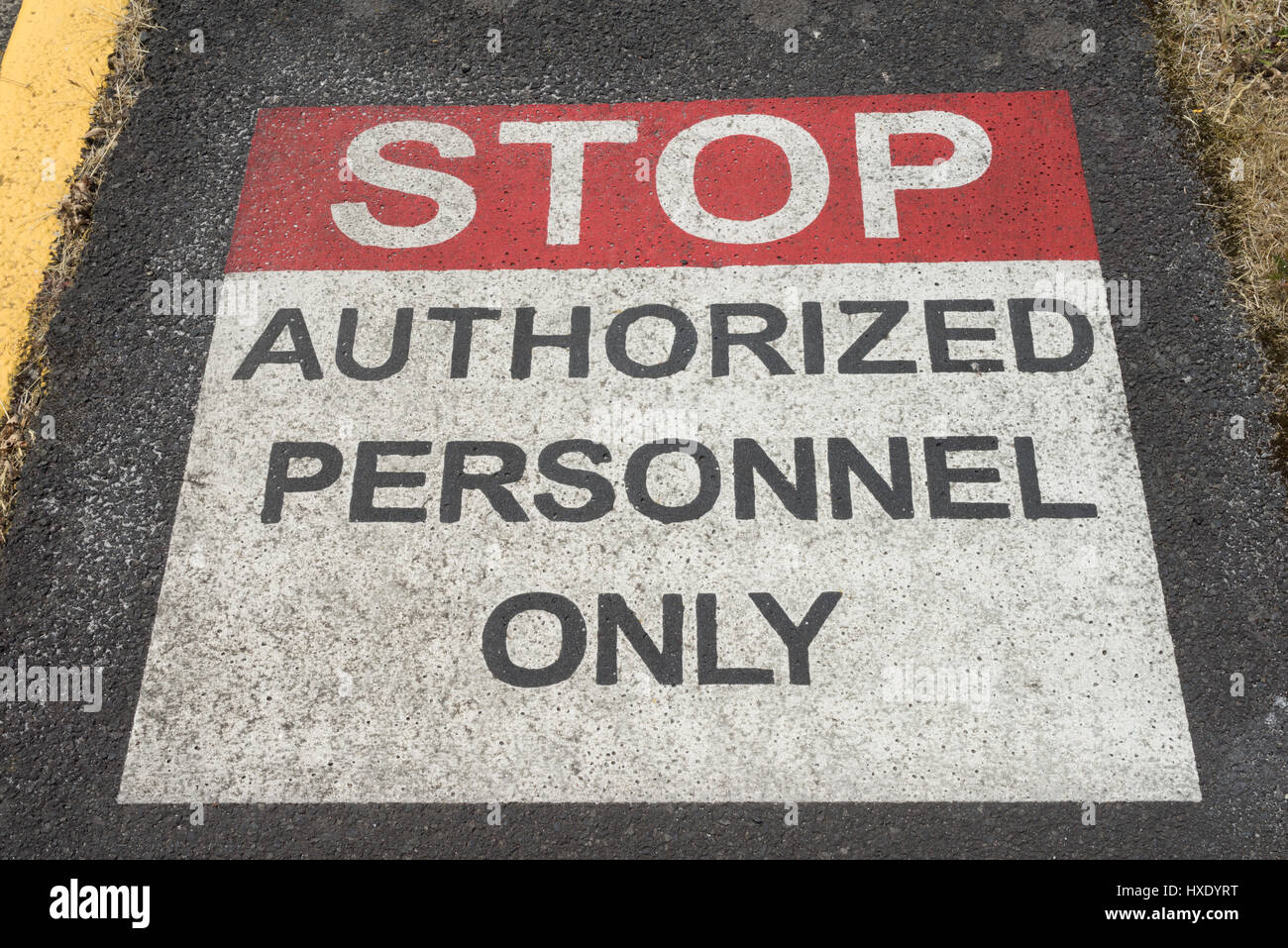 Stop Authorized Personnel Sign painted on sidewalk Stock Photo