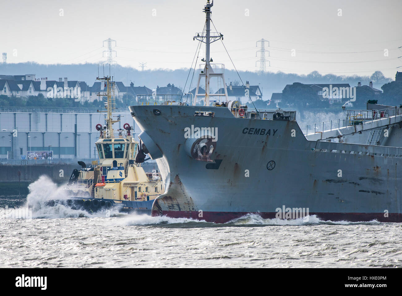 The tug Spitzer Bootle escorting the cement carrier Cembay steaming downriver on the River Thames. Stock Photo