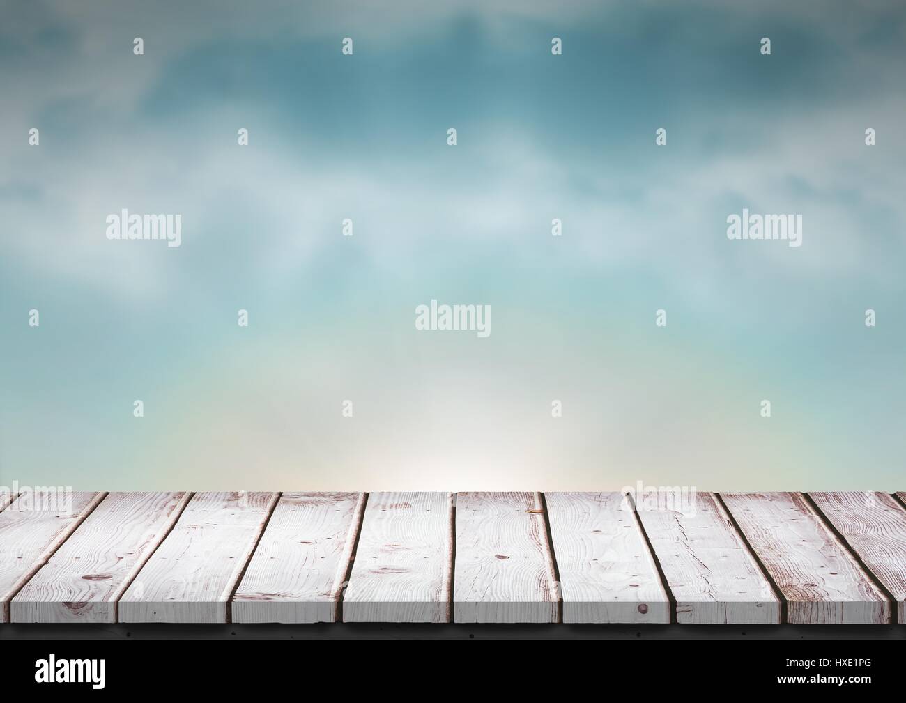 Digital composite of White wood table against blue evening sky Stock Photo