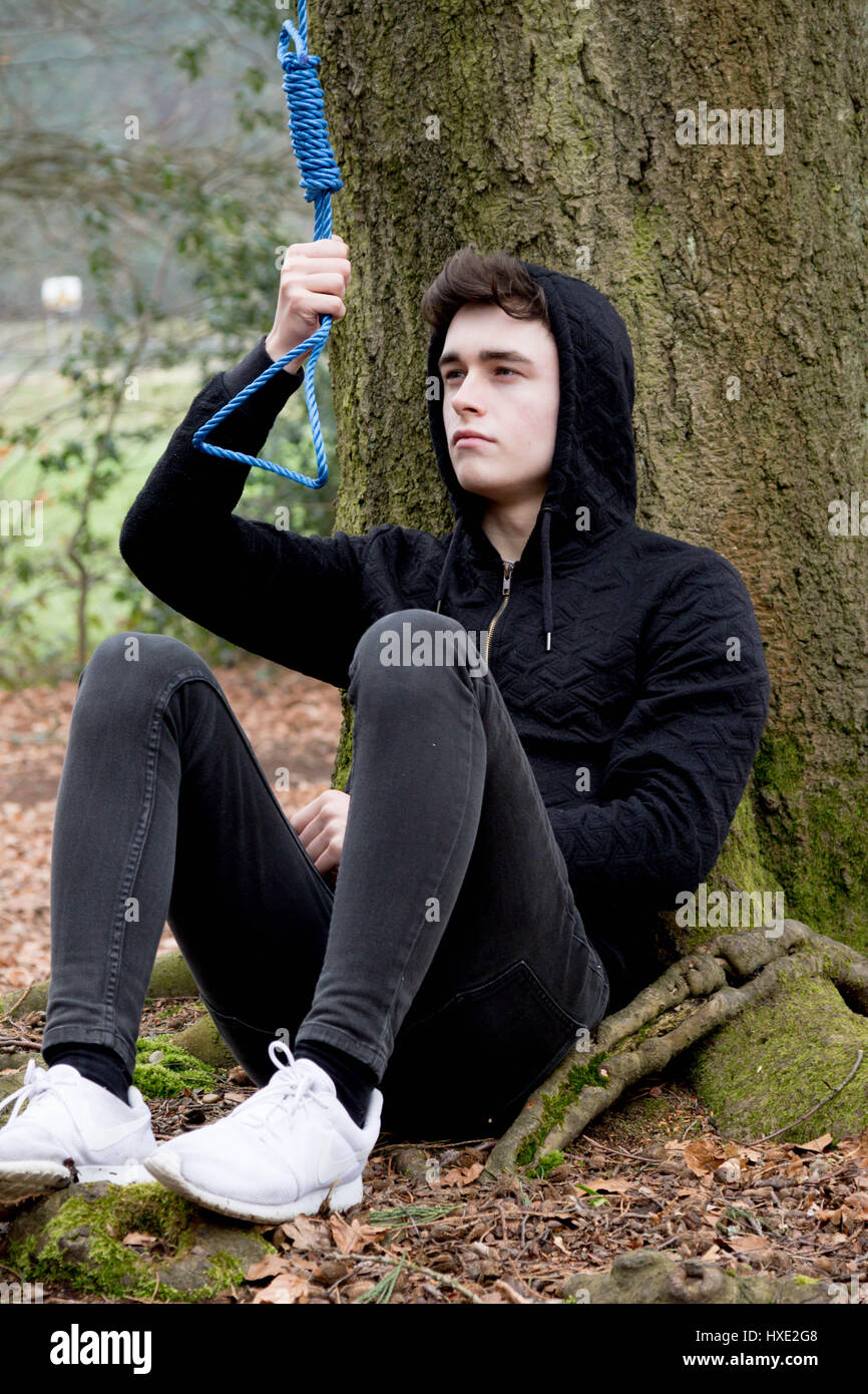 Depressed teenage boy with a hangman's noose Stock Photo