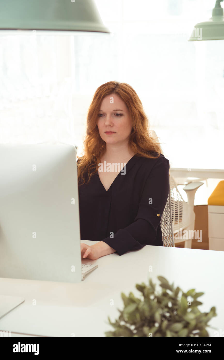 Female Executive Working On Computer At Desk In Office Stock Photo Alamy