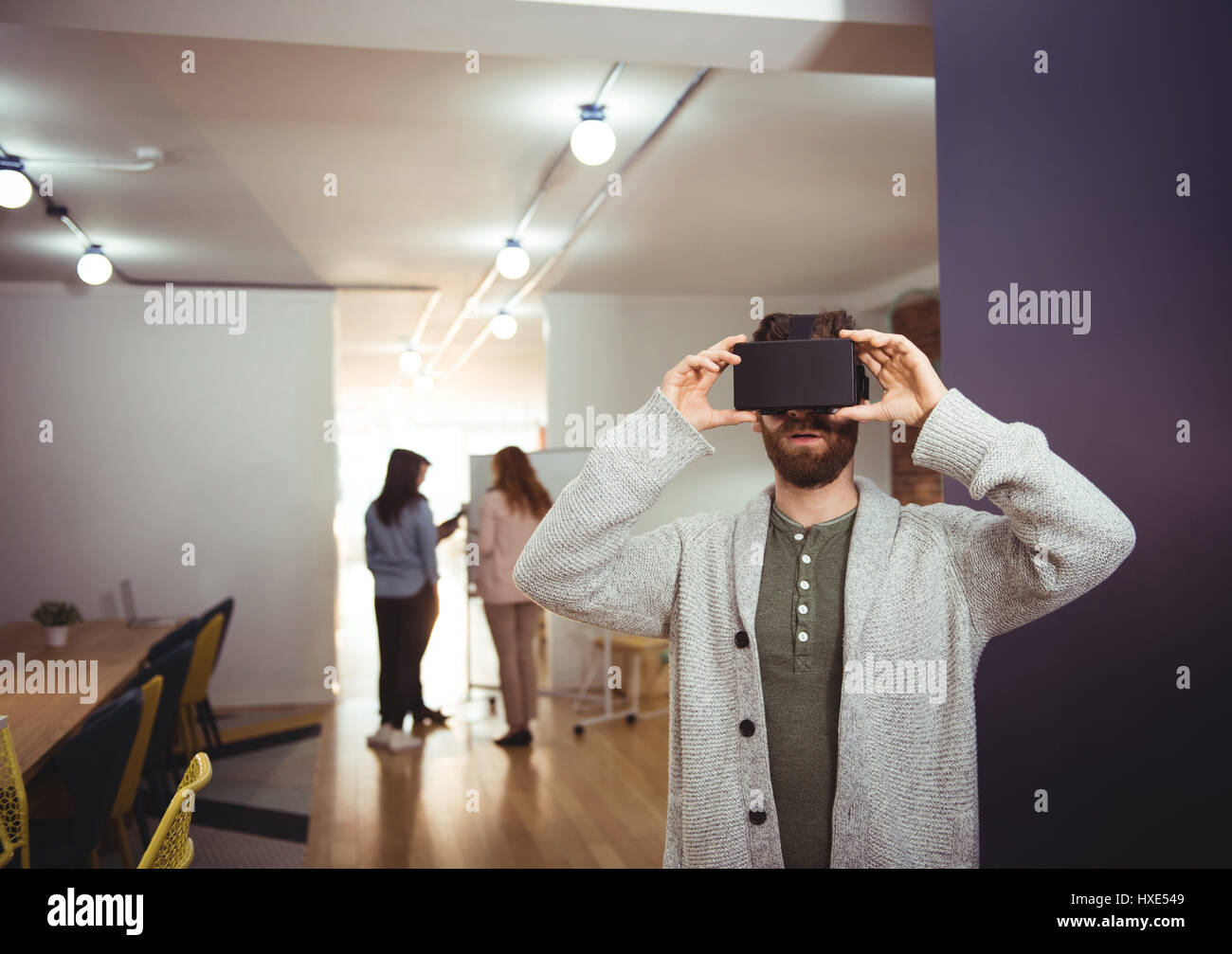 Male executive using virtual reality headset in office Stock Photo - Alamy