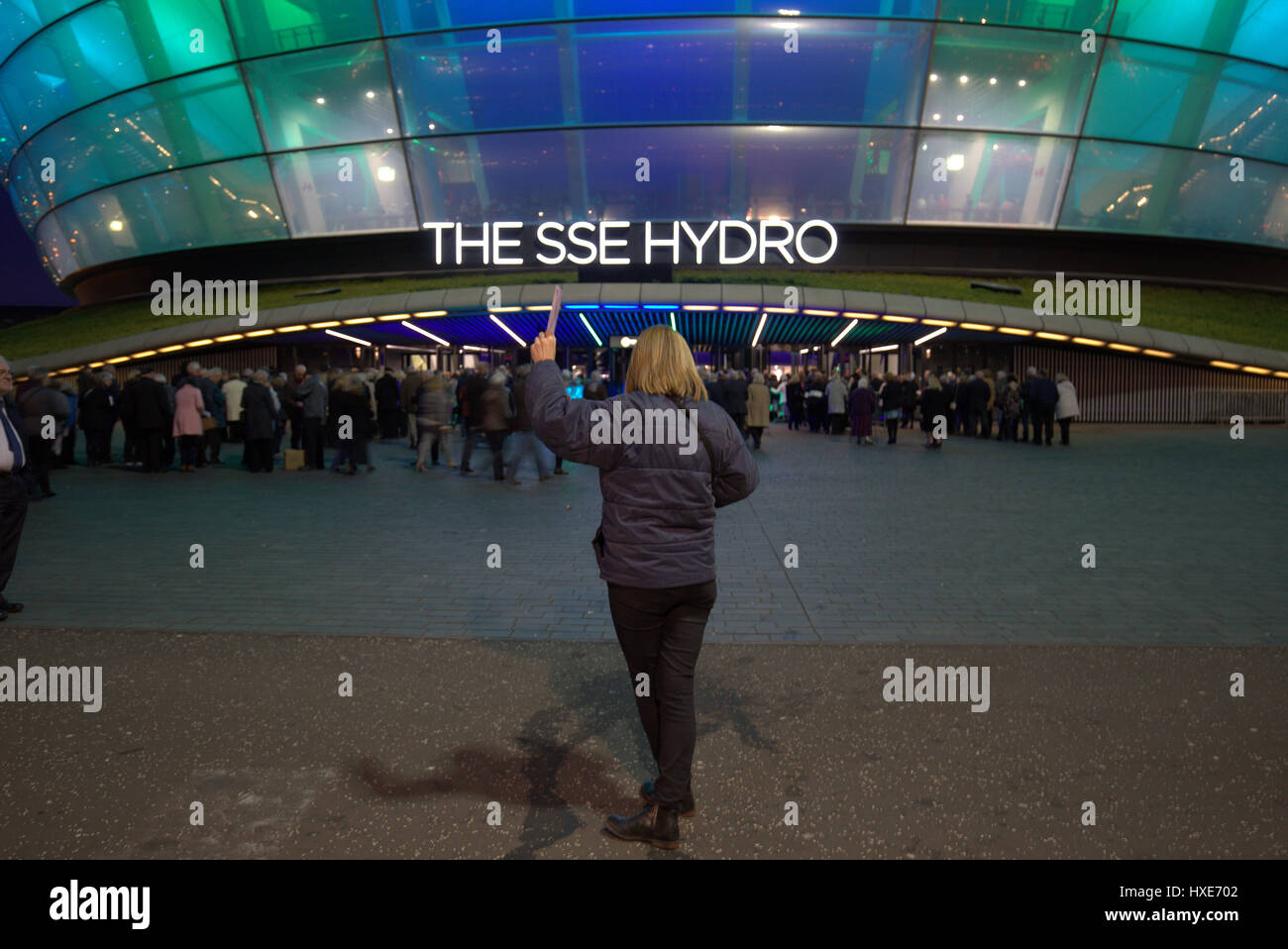 sse hydro with crowds and someone selling tickets like a ticket tout Glasgow Stock Photo