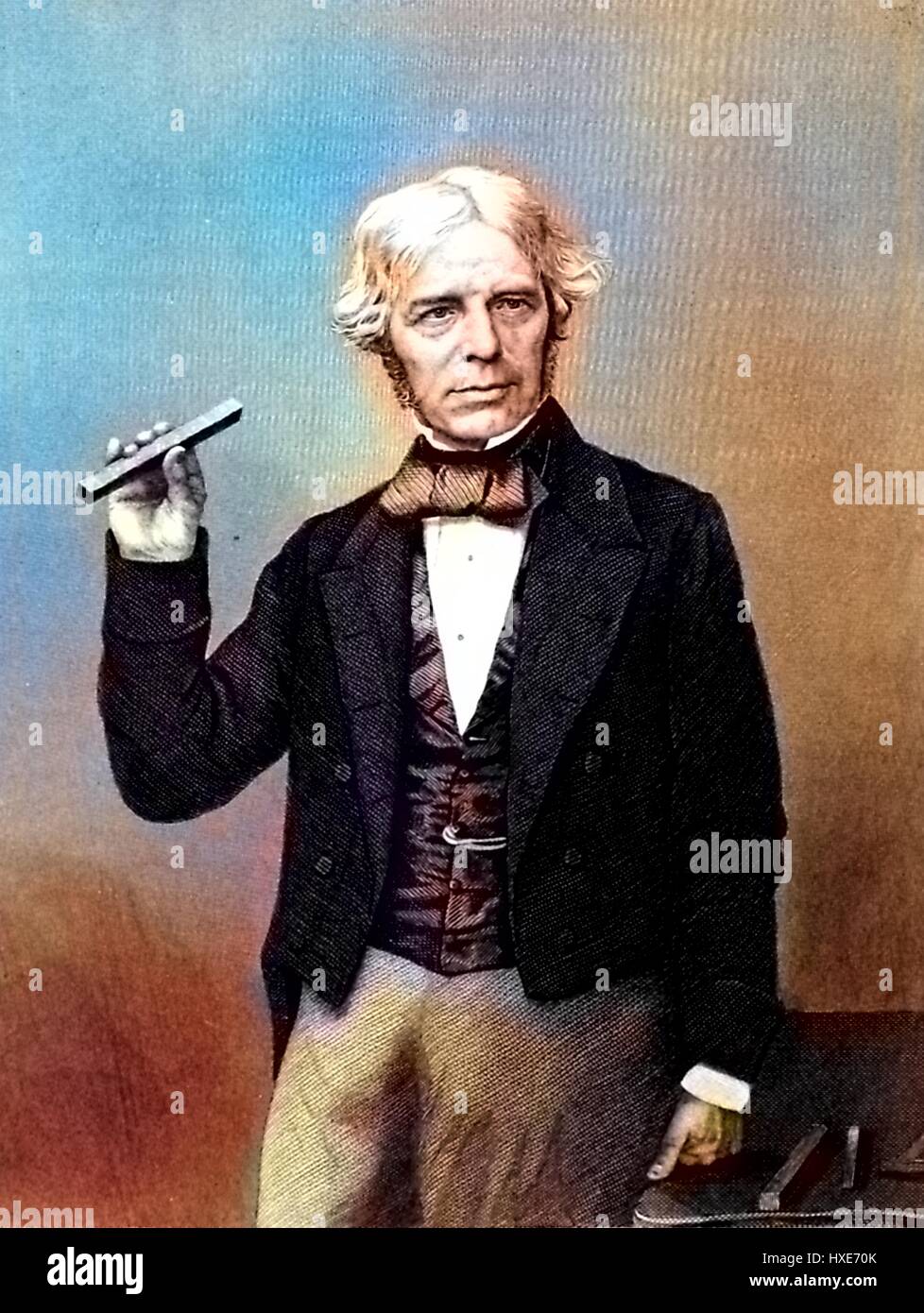 Portrait photograph of scientist Michael Faraday holding a scientific instrument and posing with his hand on a table, 1872. Note: Image has been digitally colorized using a modern process. Colors may not be period-accurate. Stock Photo