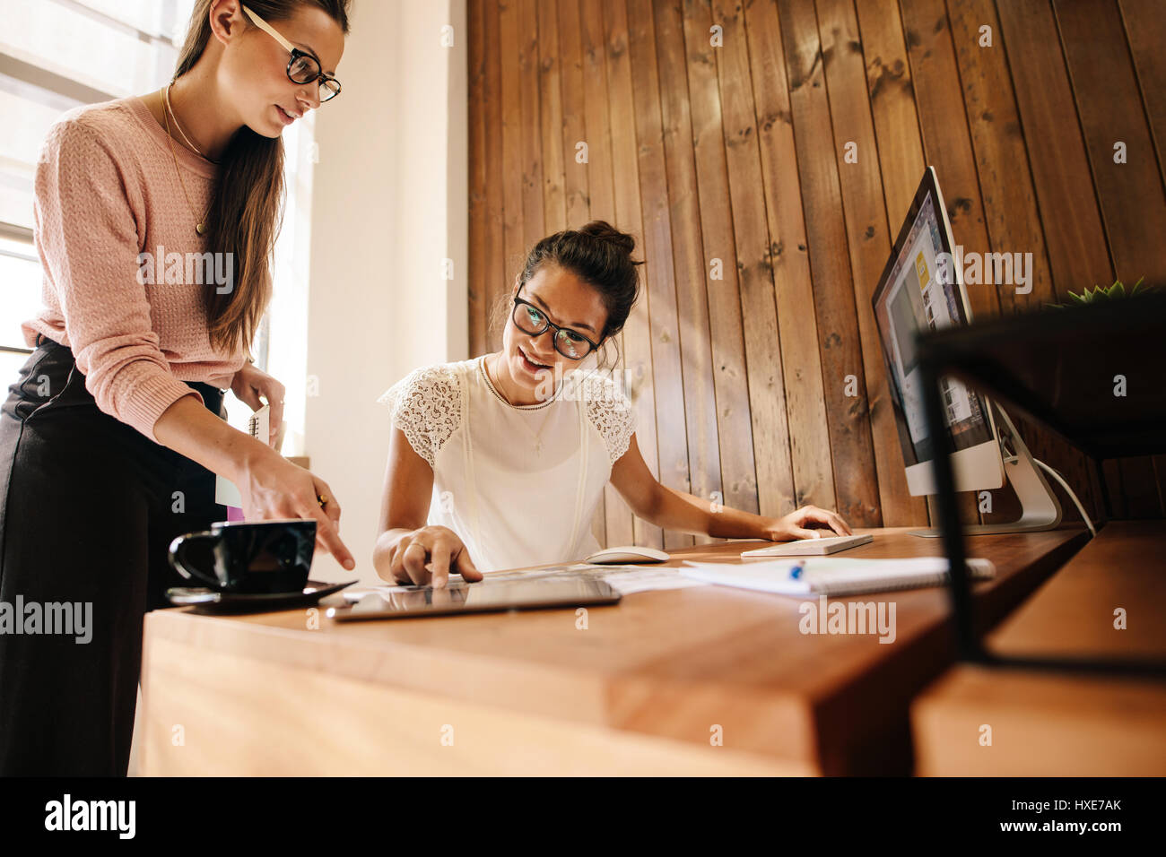 Business colleagues working together in office. Business professionals discussing new ideas on desk. Stock Photo