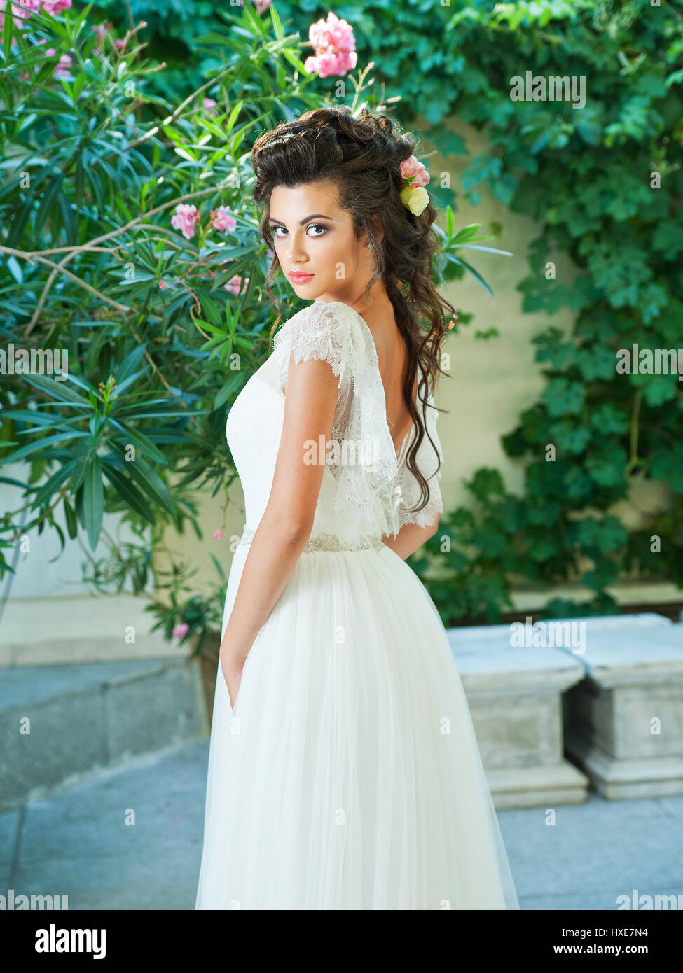 Beautiful bride in a wedding dress with a bouquet Stock Photo - Alamy