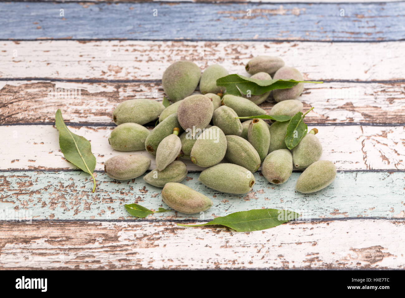 Unripe fresh almonds on vintage table side view Stock Photo - Alamy