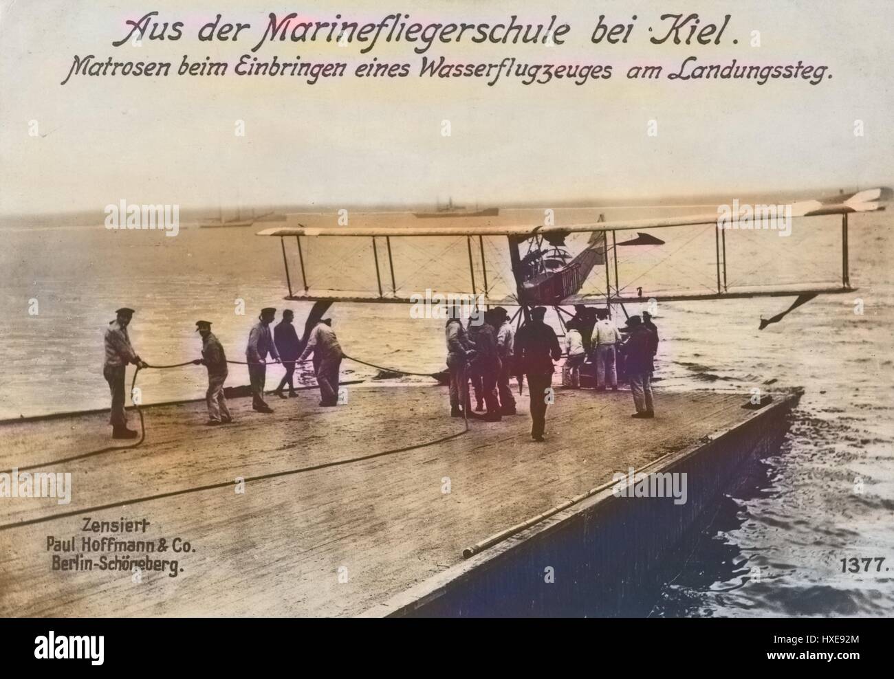 German World War I photographic postcard depicting sailors with a seaplane at the landing stage at a naval flying school near Kiel, Germany, 1915. From the New York Public Library. Note: Image has been digitally colorized using a modern process. Colors may not be period-accurate. Stock Photo