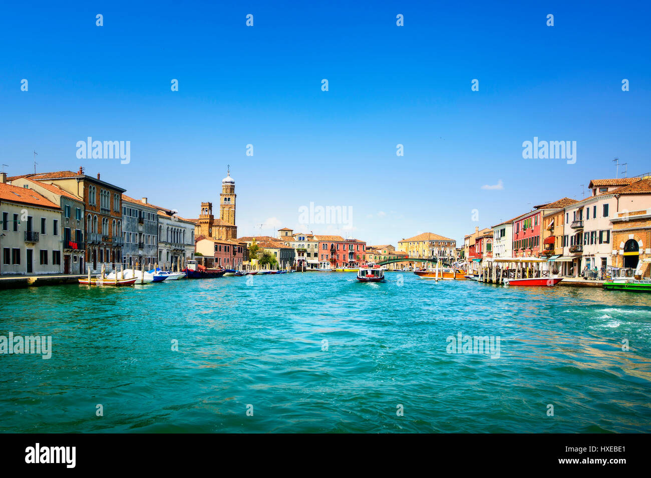 Murano glass making island, water canal, bridge, boat and traditional buildings. Venice or Venezia, Italy, Europe. Stock Photo