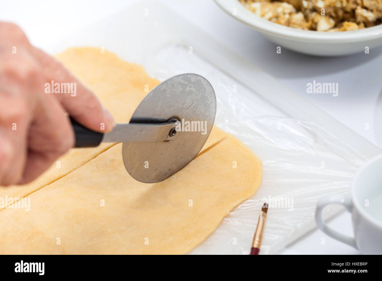 Ravioli Preparation Cutting pasta dough into strips Stock Photo Alamy