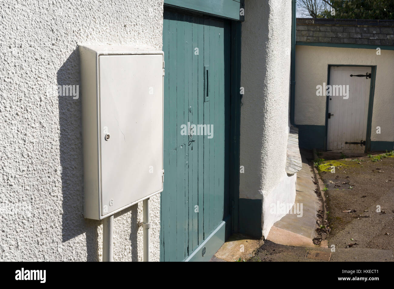 White electricity box on the wall of a house Stock Photo