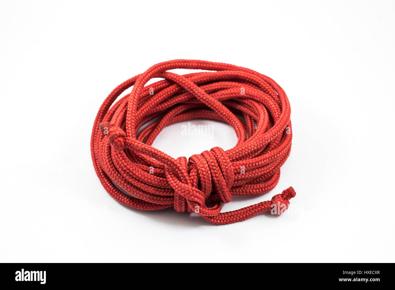 Red rope roll up isolated on white background Stock Photo - Alamy