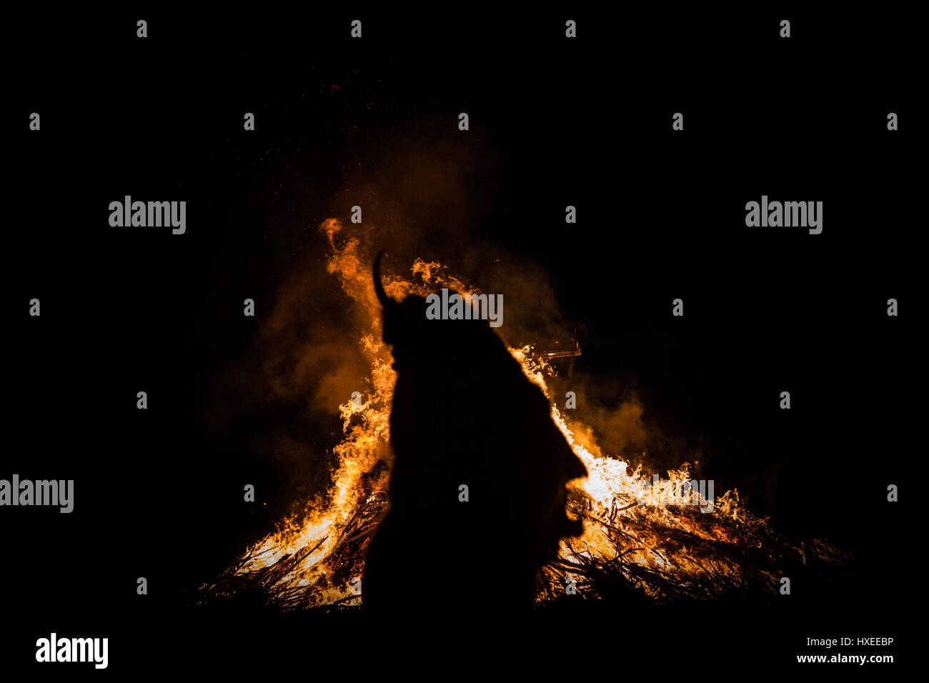 Silhouette of a 'buso' by the fire during the annual buso festivities in Mohacs, Southern Hungary Stock Photo