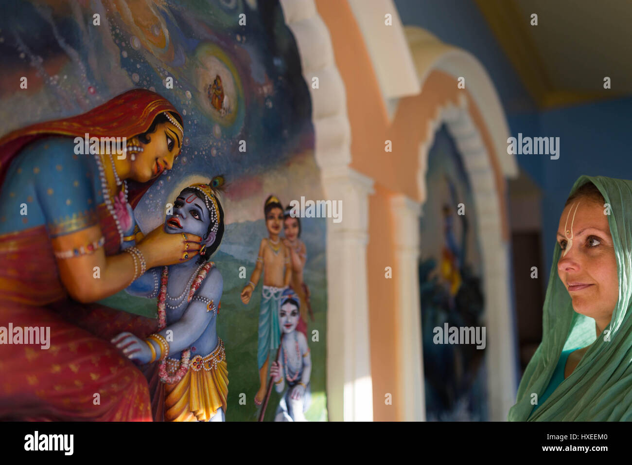 Krishna devotee woman with murals in Krishna Valley, Hungary Stock Photo