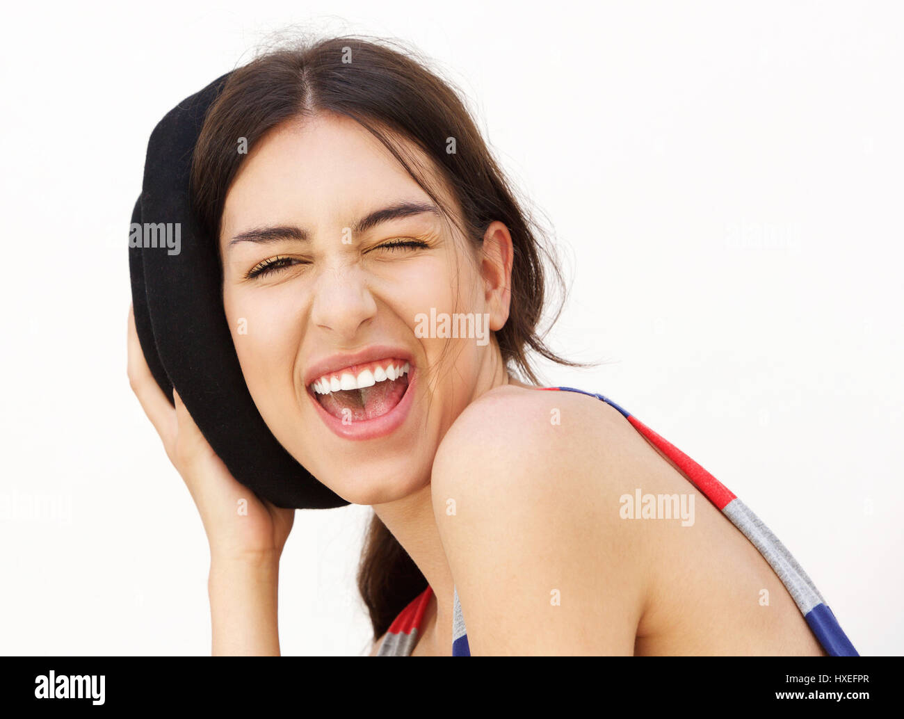 Close up portrait of a smiling girl winking eye against white ...